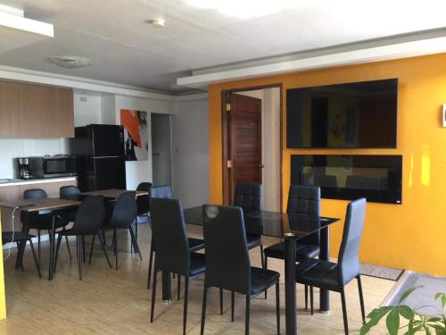 a kitchen and dining room with a table and chairs at 5 Min Walk To Famous Blue Water Resort And Tourist Area in Maribago