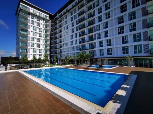 a large swimming pool in front of a tall building at Chillax @ TT3 Soho in Kuching