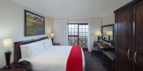 une chambre d'hôtel avec un lit et une télévision dans l'établissement The Caledon Hotel and Spa, à Caledon
