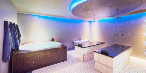 a large bathroom with a tub and a sink at The Caledon Hotel and Spa in Caledon