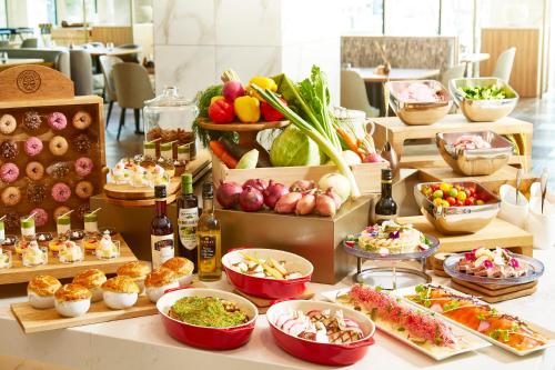 a buffet with many different types of food on a table at Courtyard by Marriott Nagoya in Nagoya