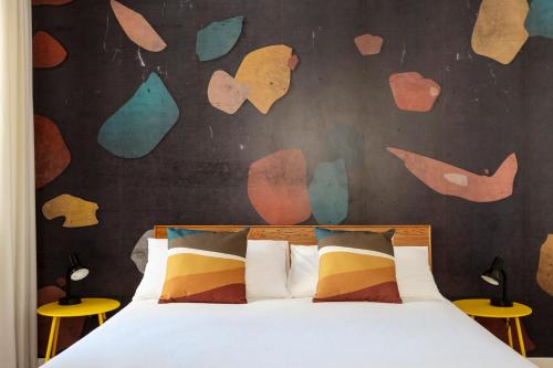 a bedroom with a bed and a wall with hearts at Casa Cervantes in Naples