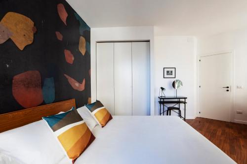 a bedroom with a large white bed with two pillows at Casa Cervantes in Naples