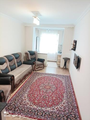 a living room with a couch and a rug at Nakhchivan Center in Naxçıvan