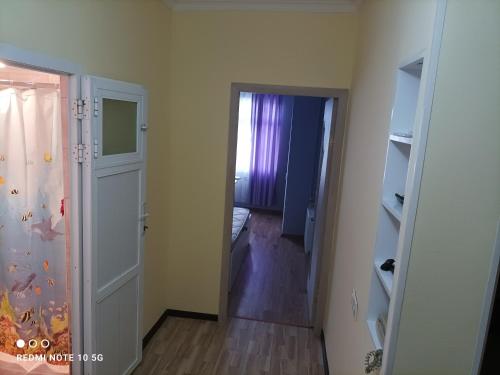 an empty room with a door leading to a bedroom at Nakhchivan Center in Naxçıvan