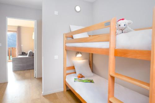 a room with two bunk beds with a teddy bear at SOWELL RESIDENCES Pra Loup in Pra-Loup