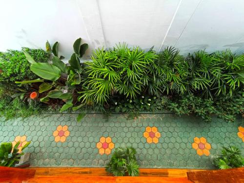 a green wall with plants on top of it at Aphilapa Residence in Chiang Mai
