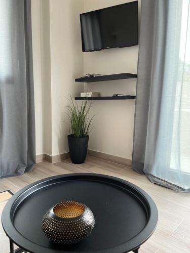 a black coffee table with a vase on top of it at Aellō luxury apartments in Markopoulo