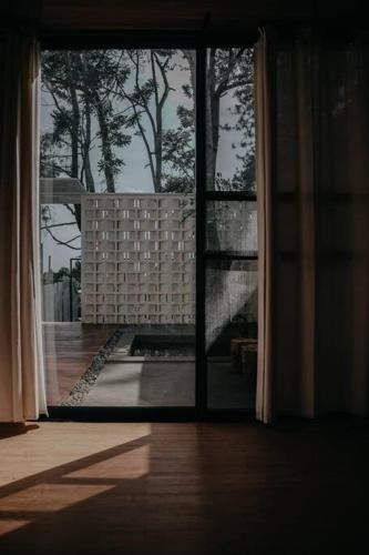 a window in a building with a view of a patio at Little Duck Villa - Tiny House near Gedong Putih in Lembang
