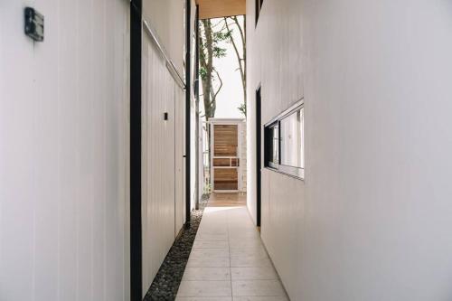 a hallway of a house with a white wall at Little Duck Villa - Tiny House near Gedong Putih in Lembang