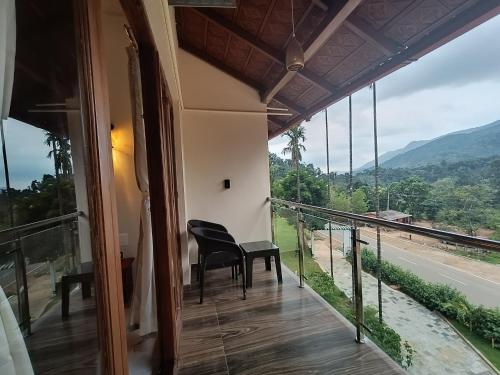 a balcony with a view of the mountains at Hill Crest Resort - Coorg in Madikeri