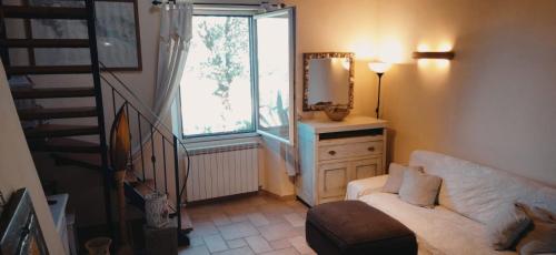 a living room with a white couch and a mirror at Casa vacanze Luna in Portovenere