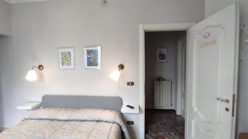 a bedroom with a bed in a white room at Villa Cecilia Bed and Breakfast in Cellole