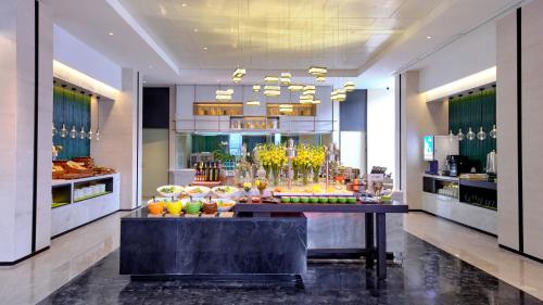 a lobby with a table with fruit on it at Hampton by Hilton Shenzhen North Station in Shenzhen