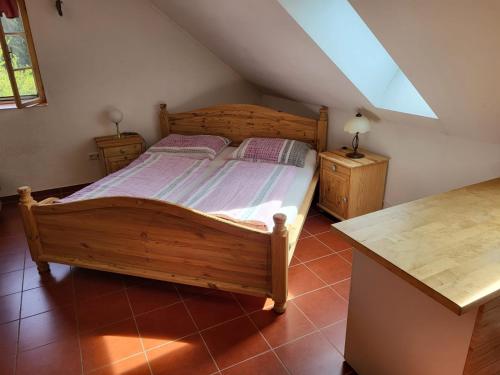 a bedroom with a wooden bed and two night stands at Ferienwohnungen Bonnleiten Familie Stöger in Stössing