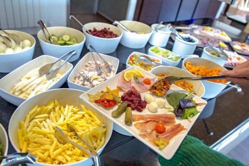a buffet with many plates of food on a table at SOWELL RESIDENCES Pra Loup in Pra-Loup