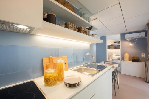 a kitchen with a sink and a counter at Club del Sole Romagna Family Resort in Riccione