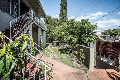 a house with a staircase next to a building at Room in Shared Apartment U1M in Brisbane