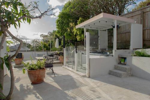 a pavilion in a garden with a table and chairs at Room in Shared Apartment U1M in Brisbane