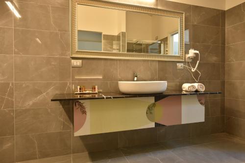 a bathroom with a sink and a mirror at Royal Garden luxury rooms in Padova