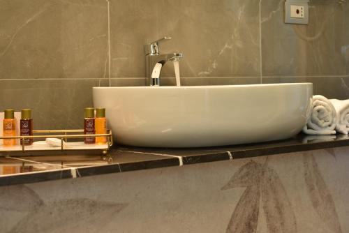 a white sink on a counter in a bathroom at Royal Garden luxury rooms in Padova