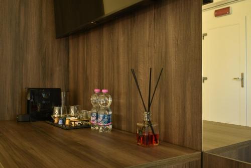 a counter with two bottles of water and drinks at Royal Garden luxury rooms in Padova