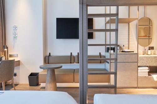 a bedroom with a bunk bed and a table at Nine Tree Premier ROKAUS Hotel Seoul Yongsan in Seoul