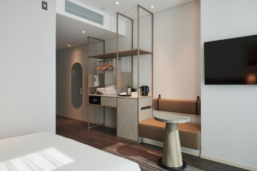 a hotel room with a bed and a tv at Nine Tree Premier ROKAUS Hotel Seoul Yongsan in Seoul