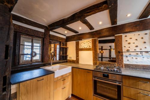 a kitchen with wooden cabinets and a sink and a stove at Haus zum Ring in Adenau