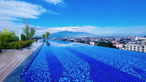 een groot zwembad met een stad op de achtergrond bij new sky pool gym sauna condo with 1 bedroom in city in Chiang Mai