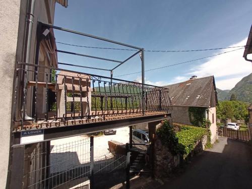 a balcony on a building with a cow on it at Maison calme et lumineuse in Cierp