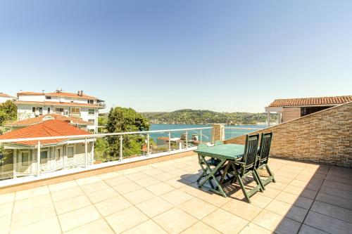 a patio with a table and chairs on a balcony at Bosphorus View Flat With Terrace in Arnavutkoy in Istanbul