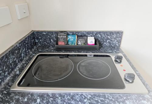 a kitchen counter with a sink and a stove at Captain Cook Motor Lodge in Gisborne