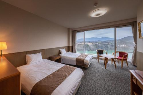 Cama o camas de una habitación en Enakyo Onsen Hotel Yuzuriha
