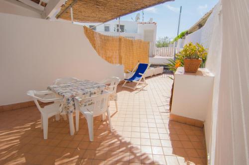 a patio with a table and chairs on a balcony at Lucia Maison in Ischia