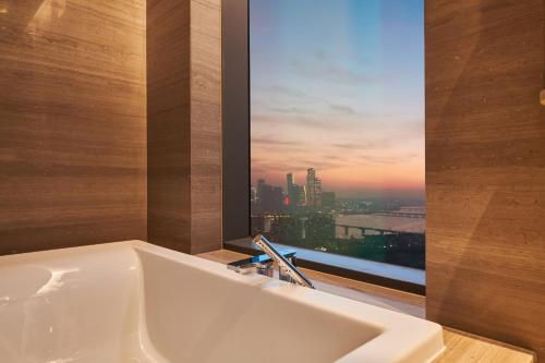 a bath tub in a bathroom with a window at Nine Tree Premier ROKAUS Hotel Seoul Yongsan in Seoul