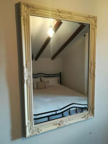 a mirror reflecting a bed in a bedroom at Elektra Apartment-Kallithea in Kallithea Rhodes