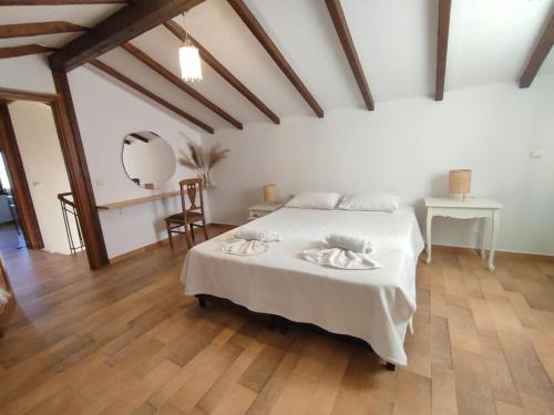 a bedroom with a white bed and a wooden floor at Elektra Apartment-Kallithea in Kallithea Rhodes
