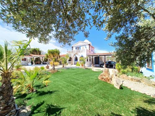 an exterior view of a house with a yard at Luxury Villa Claudia in L'Ametlla de Mar