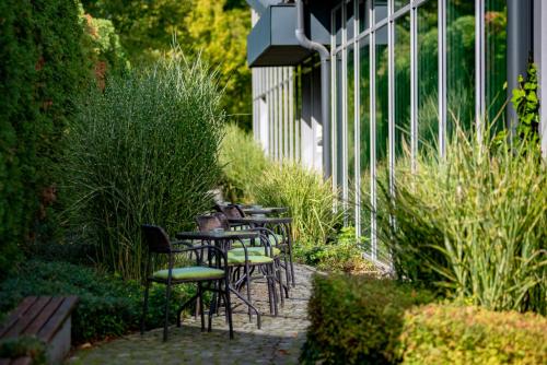 a row of tables and chairs in a garden at Prónay-kastély in Alsópetény