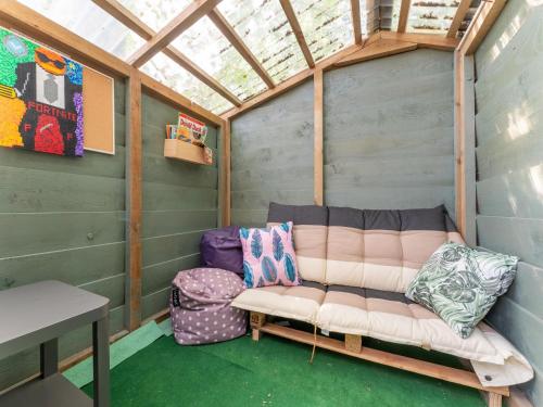a couch sitting in the inside of a house at Luxury chalet near Ouddorp with garden in Goedereede
