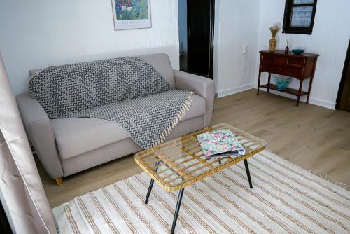 a living room with a couch and a coffee table at Les chambres du Roc in Le Roc