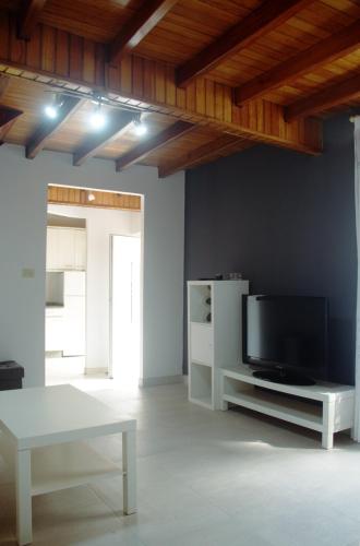 a living room with a tv and a table at Casa da Castañuela in Muros