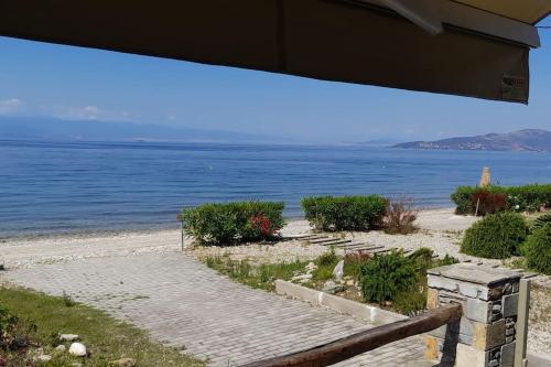 a view of a beach with a bench and the water at Antel's Leisure Beach House Pelion in Volos