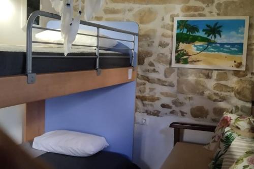 a room with a bunk bed with a pillow and a picture at Gallery House Plouti in Ploutí