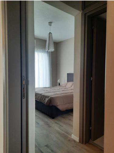 a bedroom with a bed and a large window at Semeli The 3As Armonia, Ariadne, Artemis in Paphos City