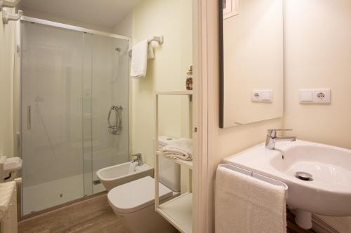 a bathroom with a sink and a toilet and a shower at El Jardí de Can Prat in Ripoll