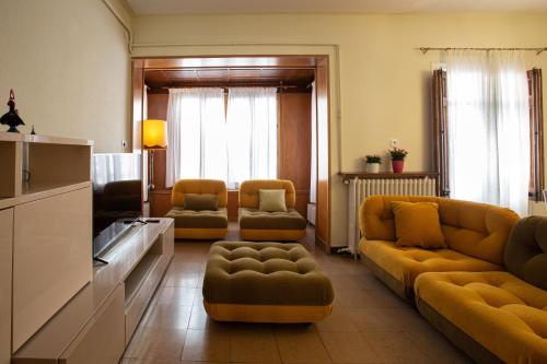 a living room with a couch and two chairs at El Jardí de Can Prat in Ripoll