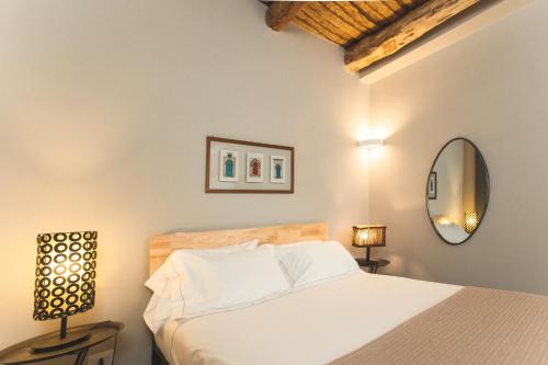 a bedroom with a white bed and a mirror at i Cacciagalli Wine Resort in Teano