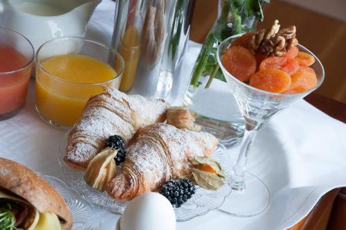 a table with a plate of pastries and a bowl of fruit at Ronnums Herrgård in Vargön